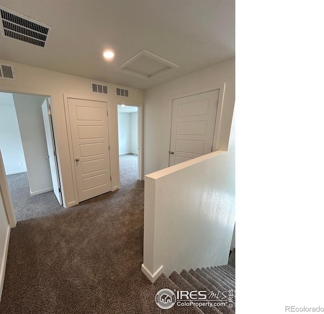 420 Condor Way, Johnstown, CO 80534 - hallway with dark colored carpet, an upstairs landing, recessed lighting, attic access, and baseboards