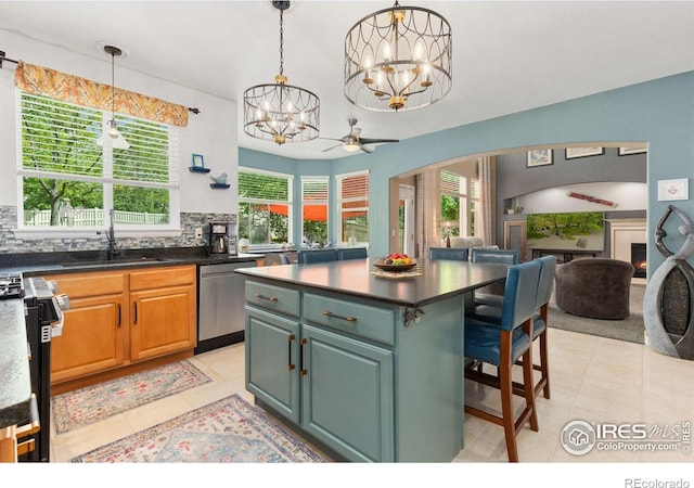 10278 Dover St, Firestone, CO 80504 - kitchen with stainless steel dishwasher, light tile patterned floors, a sink, a chandelier, and backsplash