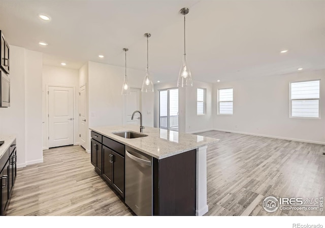 1875 Foggy Brook Dr, Fort Collins, CO 80528 - kitchen with a sink, stainless steel dishwasher, light wood-style floors, baseboards, and a kitchen island with sink