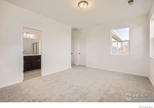 1875 Foggy Brook Dr, Fort Collins, CO 80528 - unfurnished bedroom featuring light colored carpet, baseboards, ensuite bathroom, and a sink
