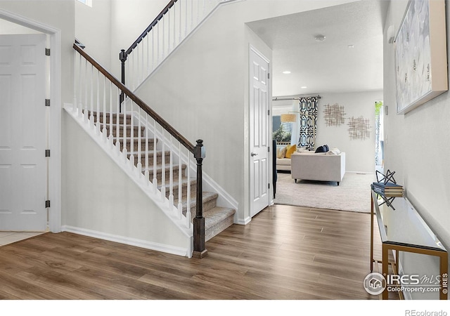 6229 Black Mesa Rd, Frederick, CO 80516 - entrance foyer with wood finished floors, stairway, baseboards, and recessed lighting