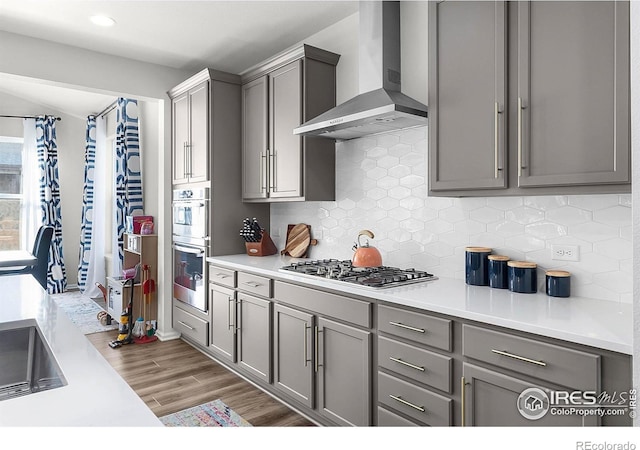 6229 Black Mesa Rd, Frederick, CO 80516 - kitchen featuring wall chimney exhaust hood, gray cabinets, appliances with stainless steel finishes, tasteful backsplash, and recessed lighting