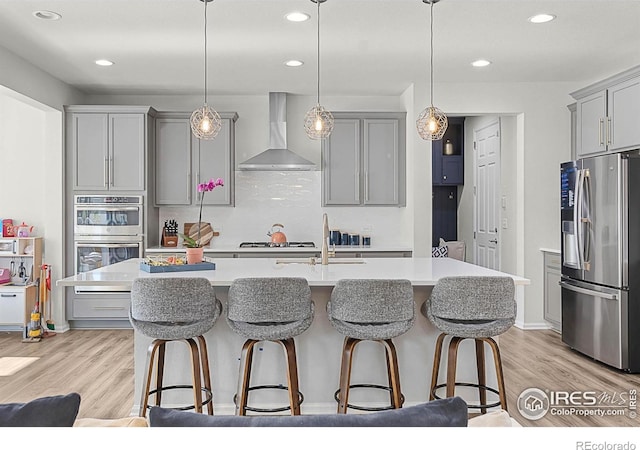 6229 Black Mesa Rd, Frederick, CO 80516 - kitchen featuring appliances with stainless steel finishes, wall chimney exhaust hood, gray cabinets, a sink, and recessed lighting