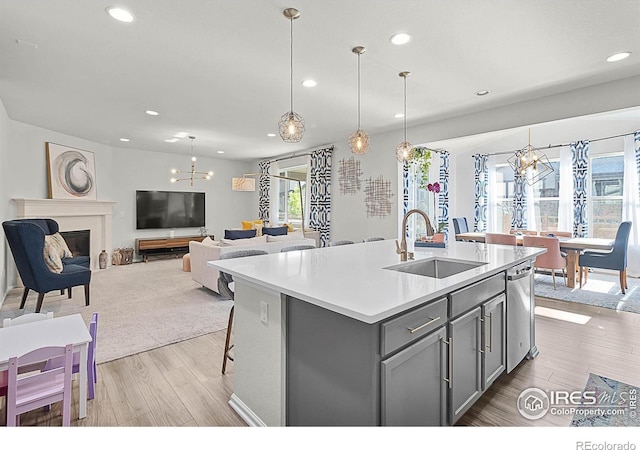 6229 Black Mesa Rd, Frederick, CO 80516 - kitchen with a sink, gray cabinets, a chandelier, recessed lighting, and wood finished floors