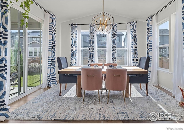 6229 Black Mesa Rd, Frederick, CO 80516 - dining area with a chandelier, vaulted ceiling, and wood finished floors