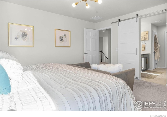 6229 Black Mesa Rd, Frederick, CO 80516 - tiled bedroom with a barn door and connected bathroom
