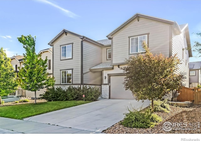 6229 Black Mesa Rd, Frederick, CO 80516 - view of front of house with concrete driveway, a garage, and stone siding