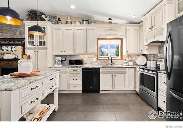 1738 S Estrella Ave, Loveland, CO 80537 - kitchen featuring appliances with stainless steel finishes, lofted ceiling, a sink, backsplash, and custom range hood