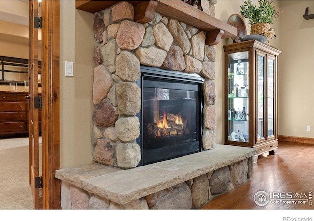 1738 S Estrella Ave, Loveland, CO 80537 - detailed view of a fireplace, baseboards, and wood finished floors