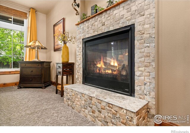 1738 S Estrella Ave, Loveland, CO 80537 - detailed view of a brick fireplace, carpet flooring, and baseboards