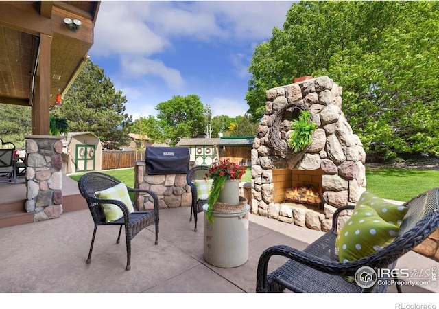 1738 S Estrella Ave, Loveland, CO 80537 - view of patio featuring an outdoor stone fireplace