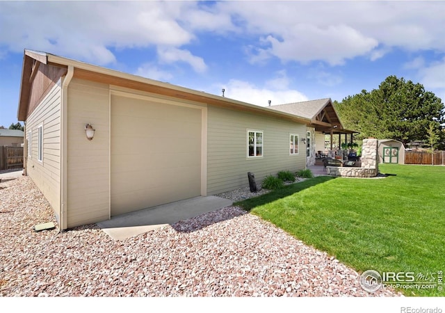 1738 S Estrella Ave, Loveland, CO 80537 - view of side of home with an outdoor structure and an attached garage