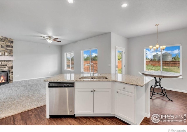 993 Ouzel Falls Rd, Severance, CO 80550 - kitchen featuring stainless steel dishwasher, a sink, open floor plan, a ceiling fan, and a chandelier