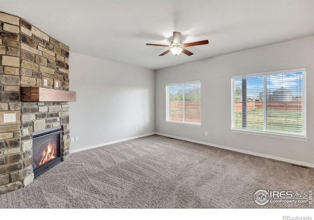 993 Ouzel Falls Rd, Severance, CO 80550 - unfurnished living room featuring ceiling fan, baseboards, a fireplace, and carpet