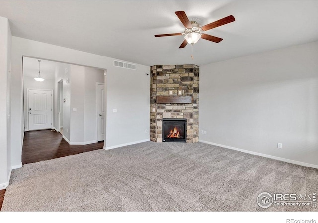 993 Ouzel Falls Rd, Severance, CO 80550 - unfurnished living room with carpet, a ceiling fan, a fireplace, and baseboards