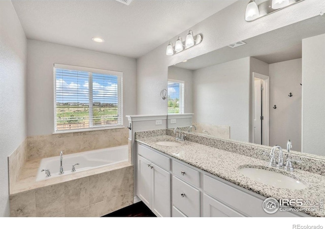 993 Ouzel Falls Rd, Severance, CO 80550 - bathroom featuring double vanity and a garden tub