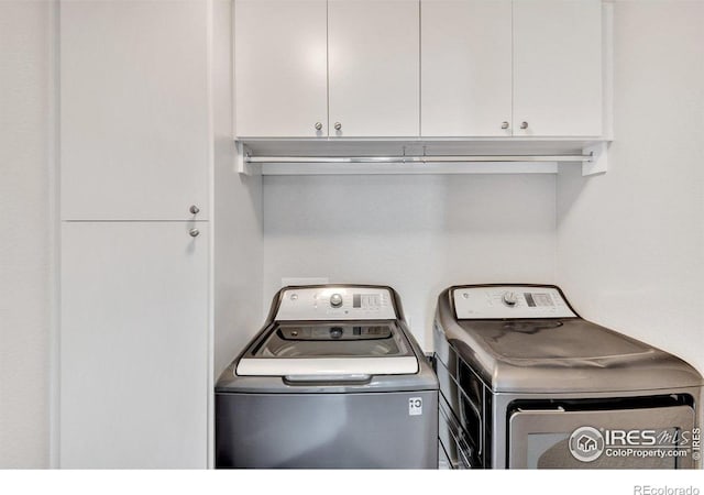 993 Ouzel Falls Rd, Severance, CO 80550 - laundry area featuring cabinet space and washing machine and clothes dryer
