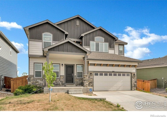 993 Ouzel Falls Rd, Severance, CO 80550 - view of front of house with stone siding, driveway, board and batten siding, and an attached garage