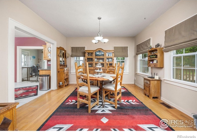 23462 County Road 55, Kersey, CO 80644 - dining room with wood finished floors, a chandelier, and baseboards