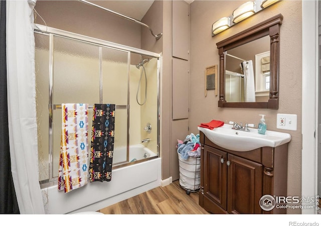 23462 County Road 55, Kersey, CO 80644 - full bath featuring wood finished floors, enclosed tub / shower combo, and vanity