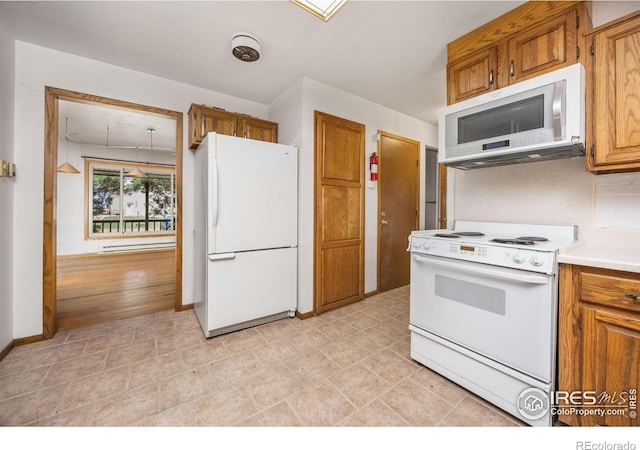 23462 County Road 55, Kersey, CO 80644 - kitchen with white appliances, brown cabinetry, light countertops, a baseboard radiator, and baseboards