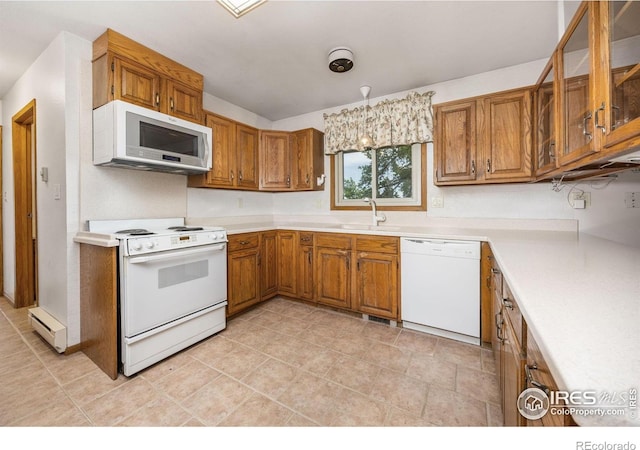 23462 County Road 55, Kersey, CO 80644 - kitchen with white appliances, brown cabinetry, a baseboard heating unit, and light countertops