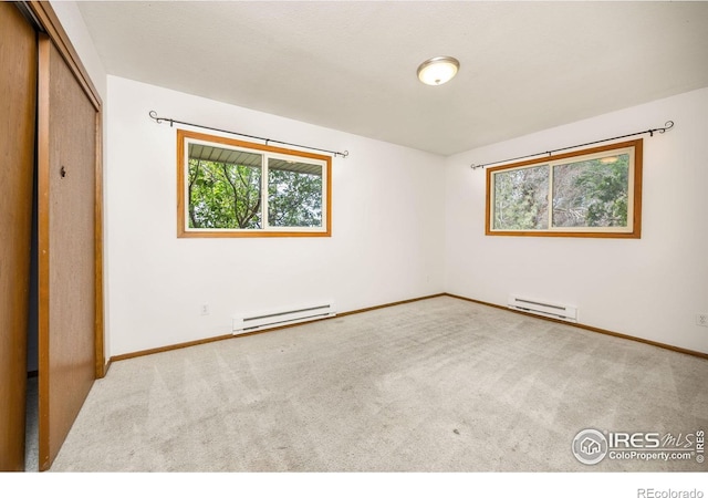 23462 County Road 55, Kersey, CO 80644 - unfurnished bedroom featuring a baseboard radiator, carpet, and baseboards