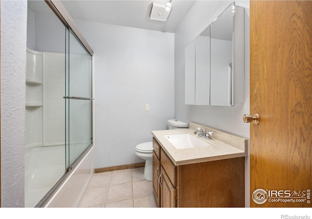 23462 County Road 55, Kersey, CO 80644 - full bathroom with vanity, toilet, tile patterned floors, combined bath / shower with glass door, and baseboards