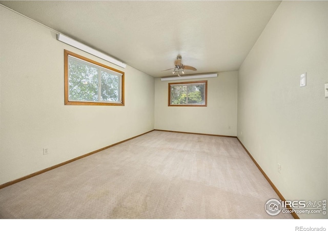 23462 County Road 55, Kersey, CO 80644 - empty room with plenty of natural light, a ceiling fan, carpet flooring, and baseboards