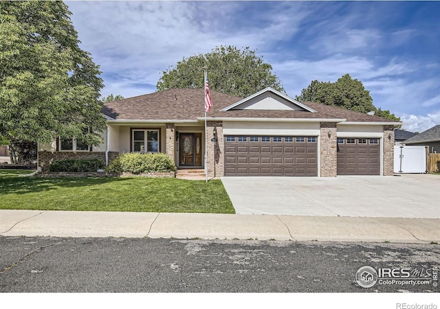 520 N Harding Ave, Johnstown, CO 80534 - single story home with an attached garage, a front lawn, brick siding, and driveway