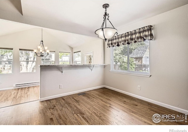 520 N Harding Ave, Johnstown, CO 80534 - unfurnished dining area with a baseboard heating unit, a chandelier, wood finished floors, baseboards, and lofted ceiling