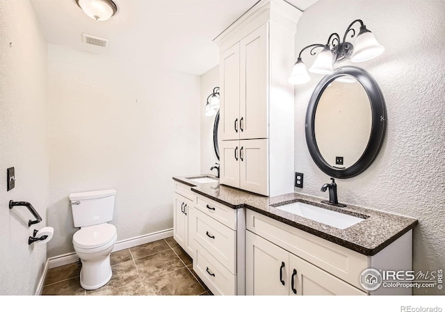 520 N Harding Ave, Johnstown, CO 80534 - full bath with double vanity, toilet, tile patterned floors, and baseboards