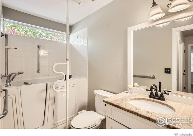 520 N Harding Ave, Johnstown, CO 80534 - bathroom featuring vanity, toilet, and a bath