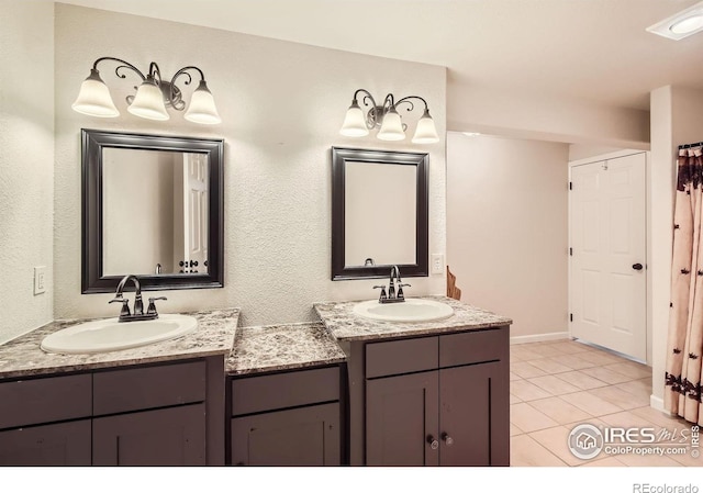 520 N Harding Ave, Johnstown, CO 80534 - full bath with two vanities, tile patterned floors, and baseboards