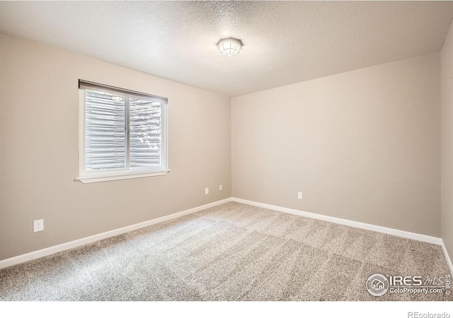 520 N Harding Ave, Johnstown, CO 80534 - empty room featuring carpet, a textured ceiling, and baseboards
