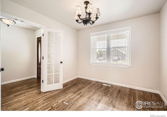 520 N Harding Ave, Johnstown, CO 80534 - spare room with a chandelier, baseboards, wood finished floors, and french doors