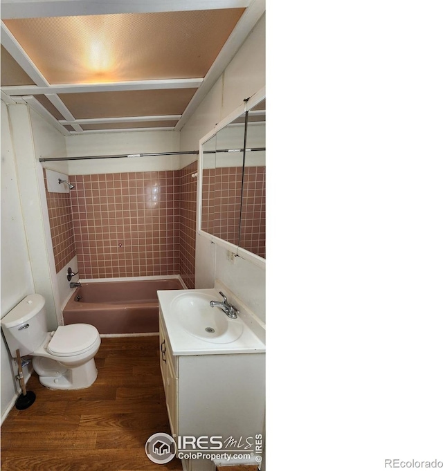 305 Phelps St, Sterling, CO 80751 - full bathroom featuring toilet, wood finished floors, vanity, and washtub / shower combination