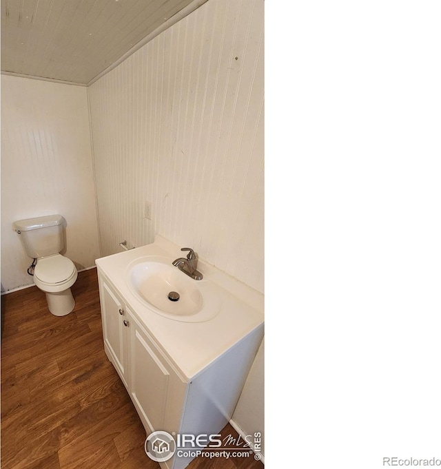 305 Phelps St, Sterling, CO 80751 - bathroom with vanity, toilet, and wood finished floors