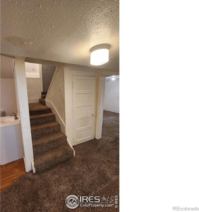 305 Phelps St, Sterling, CO 80751 - staircase with a textured ceiling and carpet flooring