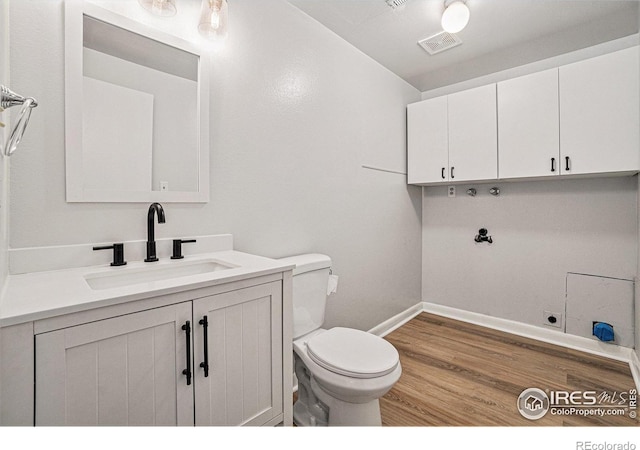 2824 Edinburgh Ct, Fort Collins, CO 80525 - bathroom featuring baseboards, toilet, vanity, and wood finished floors