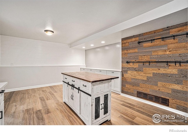 2824 Edinburgh Ct, Fort Collins, CO 80525 - kitchen featuring wood counters, light wood-type flooring, white cabinetry, baseboards, and recessed lighting