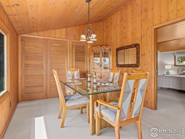 839 Ski Rd, Allenspark, CO 80510 - carpeted dining space featuring lofted ceiling, wooden walls, a chandelier, and wood ceiling