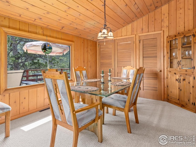 839 Ski Rd, Allenspark, CO 80510 - dining area featuring wood walls, plenty of natural light, lofted ceiling, carpet flooring, and wooden ceiling