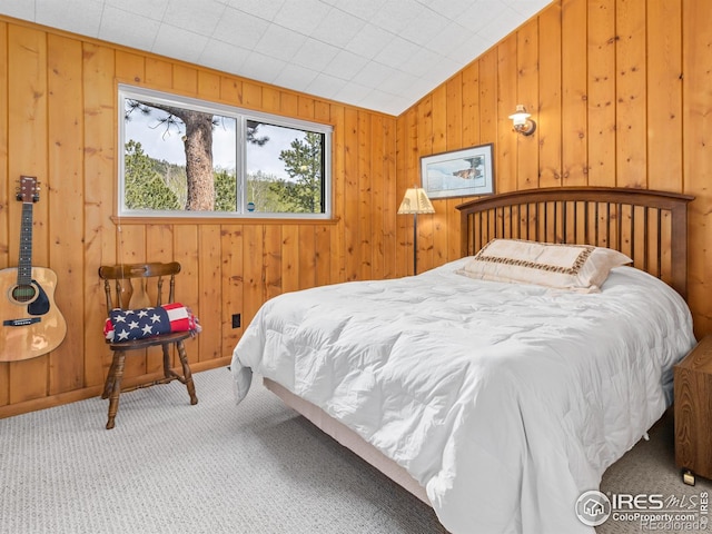 839 Ski Rd, Allenspark, CO 80510 - carpeted bedroom featuring vaulted ceiling and wood walls