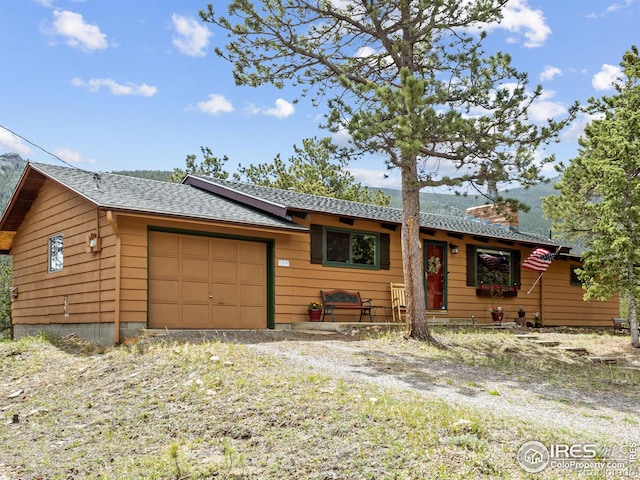 839 Ski Rd, Allenspark, CO 80510 - single story home featuring an attached garage, a shingled roof, and a chimney