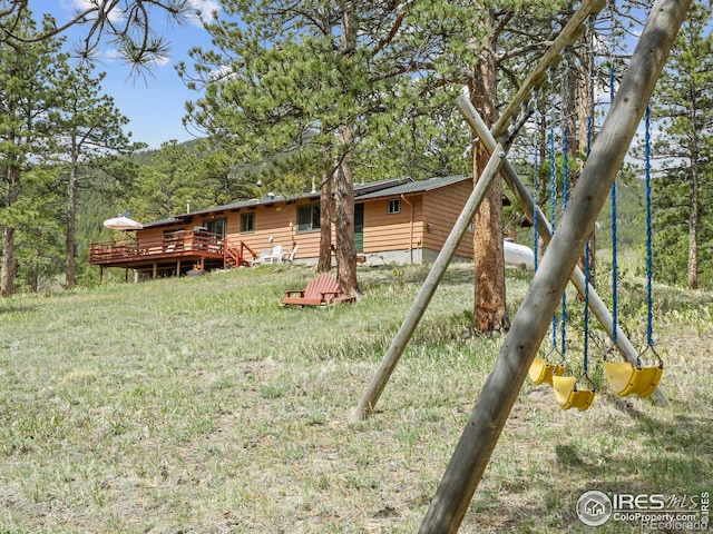 839 Ski Rd, Allenspark, CO 80510 - rear view of house with a wooden deck and a lawn