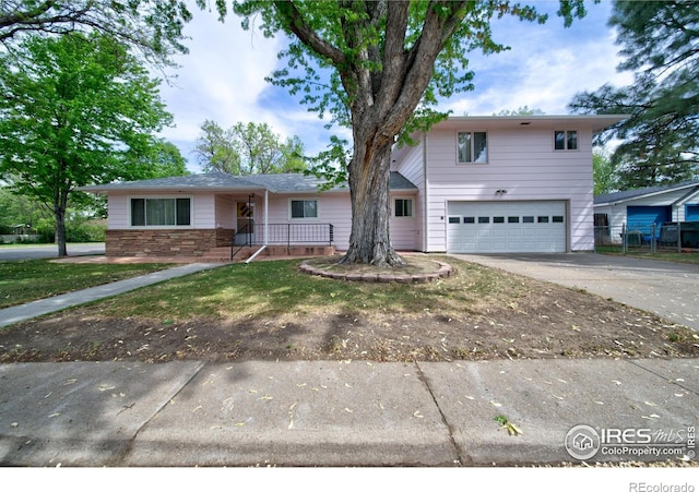 201 Howard St, Brush, CO 80723 - traditional home featuring a garage, driveway, and covered porch