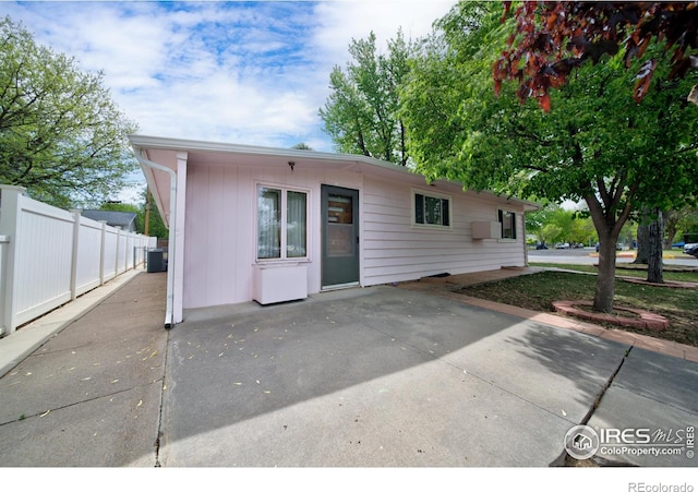 201 Howard St, Brush, CO 80723 - view of front facade with a patio area and central AC