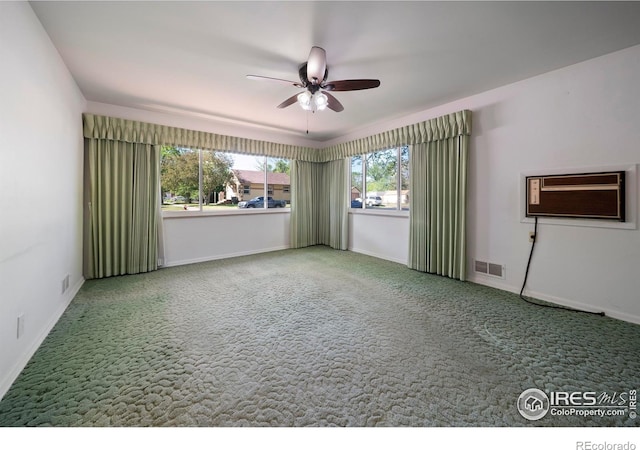 201 Howard St, Brush, CO 80723 - unfurnished room with a ceiling fan, carpet flooring, a wall mounted air conditioner, and baseboards