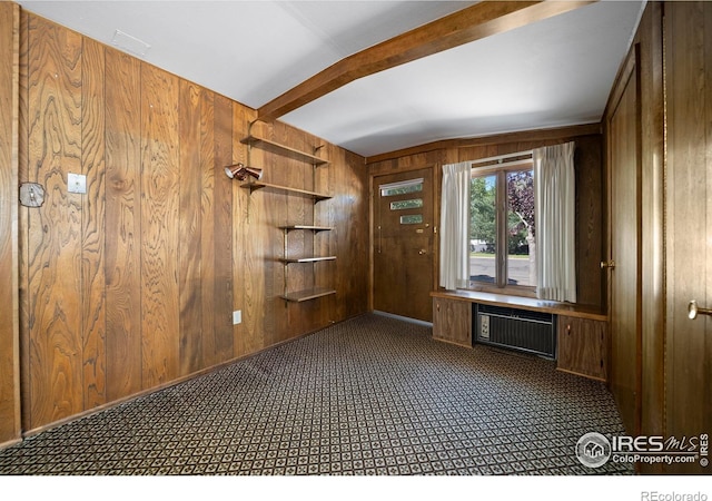 201 Howard St, Brush, CO 80723 - unfurnished office featuring wood walls, an AC wall unit, carpet, and beam ceiling